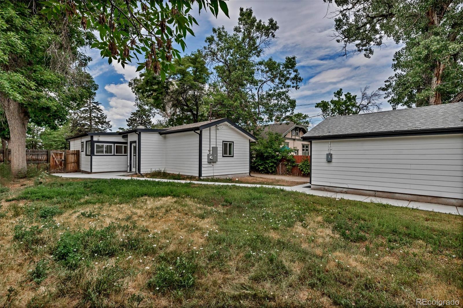 10 South Irving Street Denver, CO 80219 - Photo 31 of 35 a backyard of a house with plants and large tree