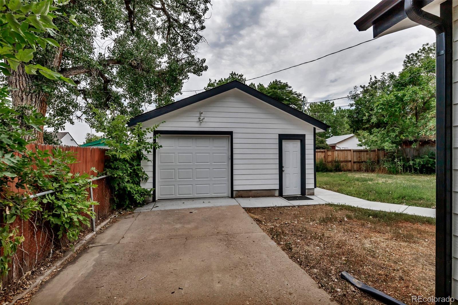10 South Irving Street Denver, CO 80219 - Photo 35 of 35 a view of a house with a small yard and garage