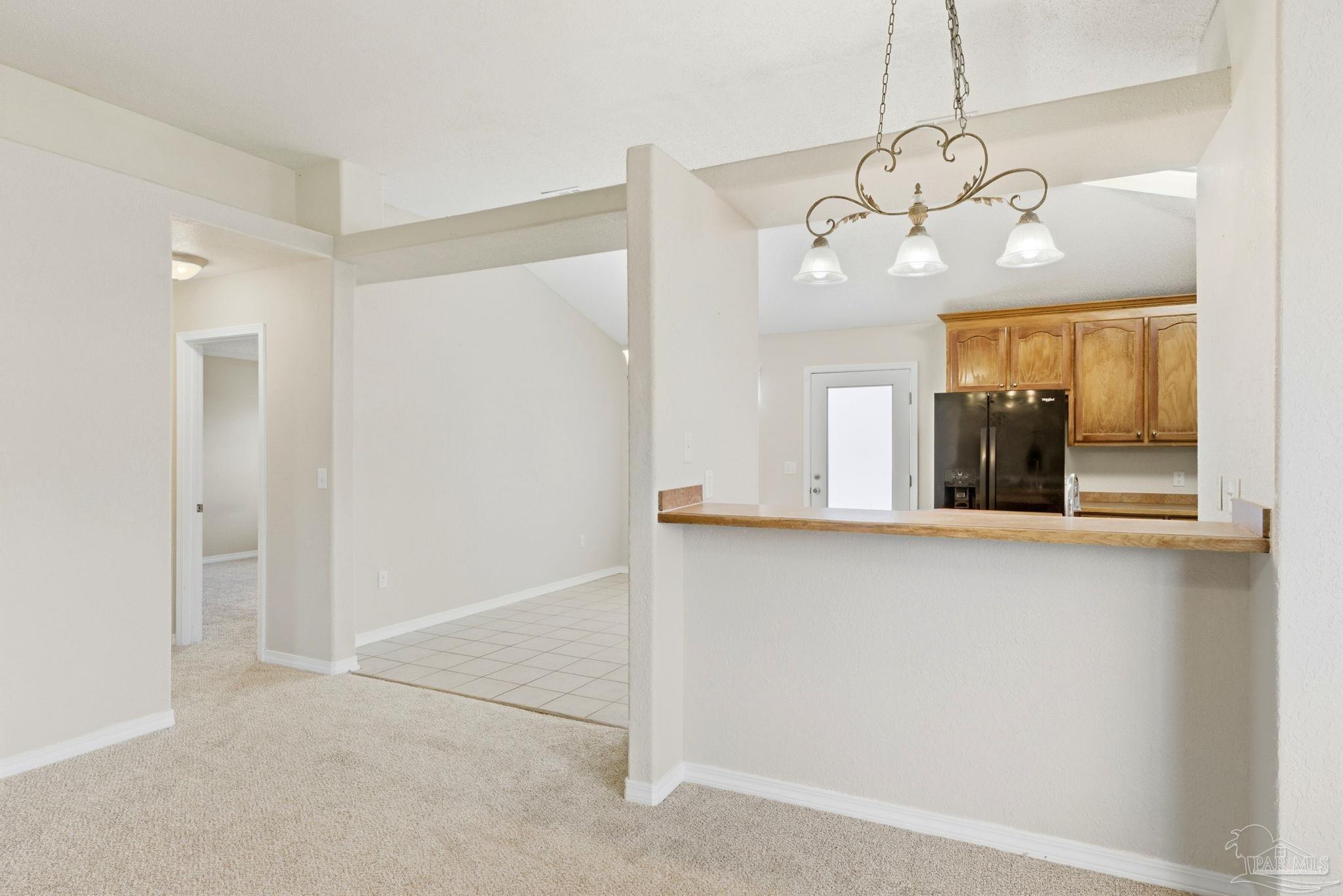 8100 Castle Pointe Way Pensacola, FL 32506 - Photo 12 of 44 a view of a room with wooden floor chandelier and windows