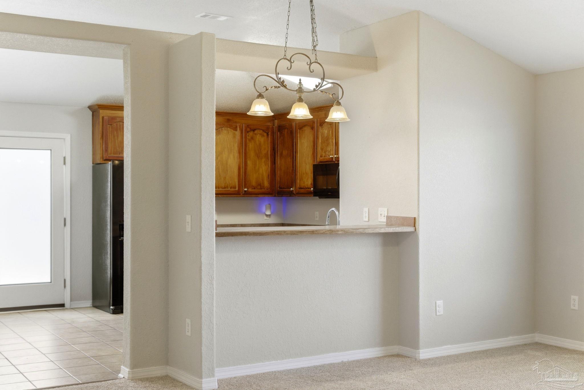 8100 Castle Pointe Way Pensacola, FL 32506 - Photo 13 of 44 a room with wooden floor and chandelier