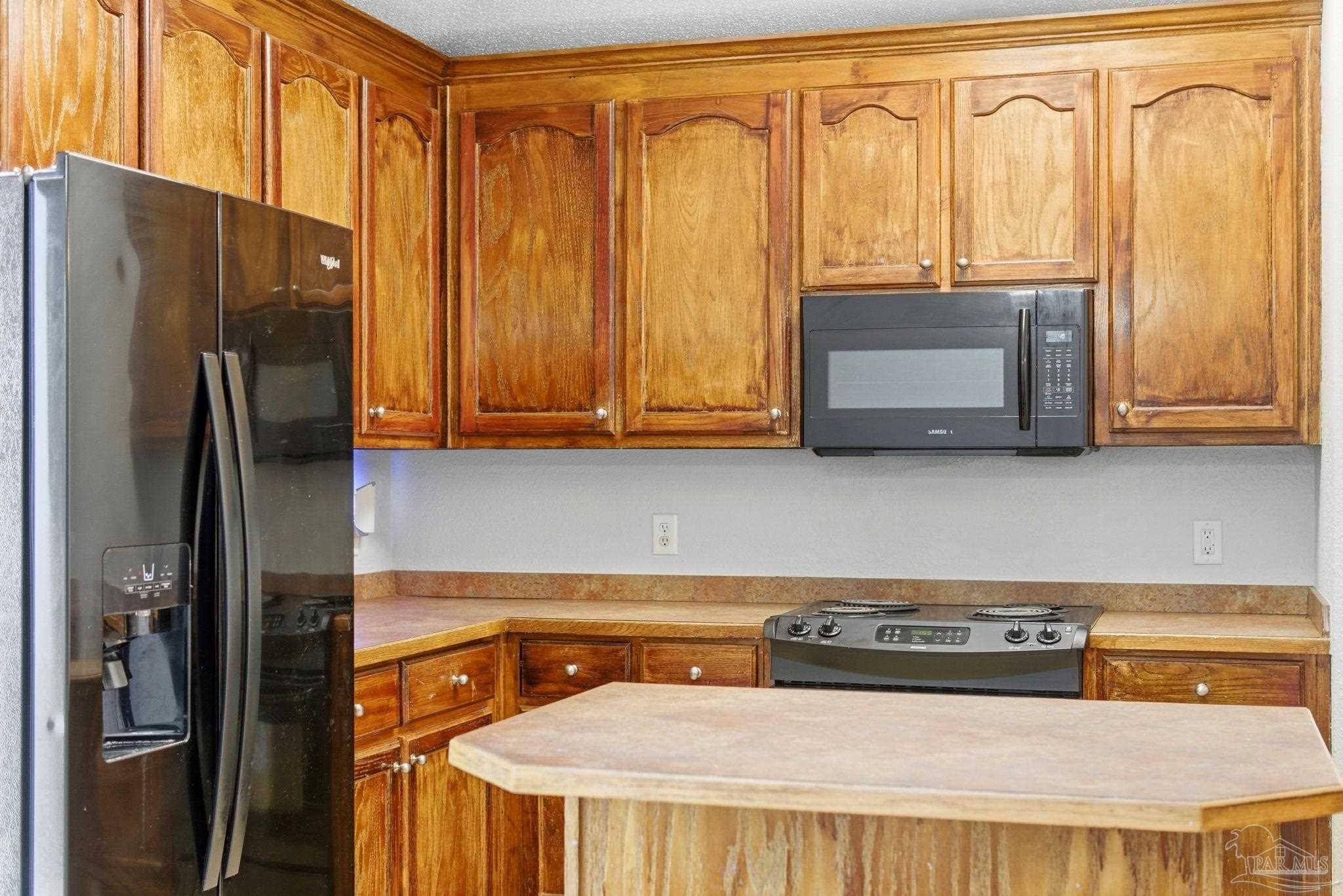 8100 Castle Pointe Way Pensacola, FL 32506 - Photo 17 of 44 a kitchen with stainless steel appliances a refrigerator and a stove