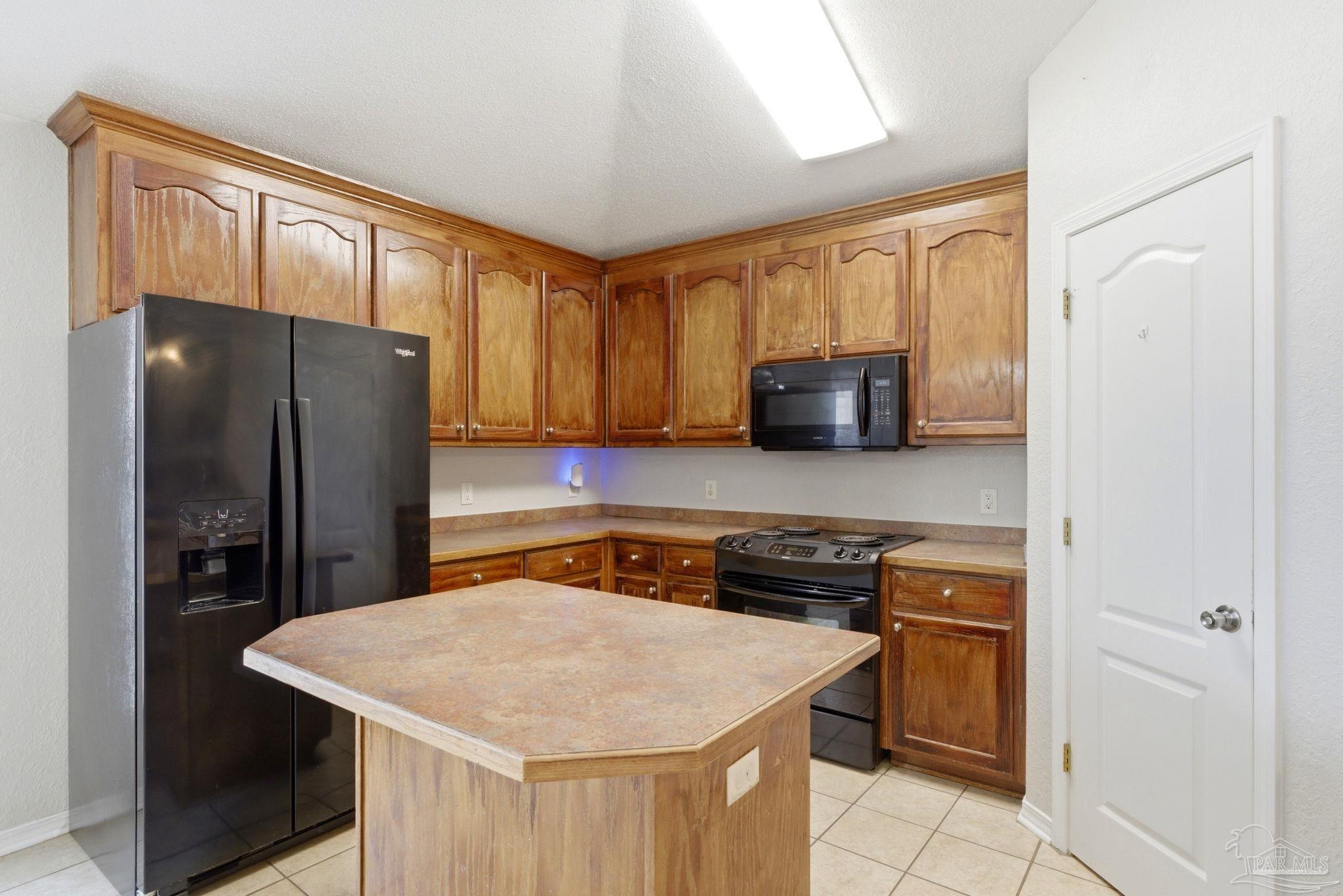 8100 Castle Pointe Way Pensacola, FL 32506 - Photo 18 of 44 a kitchen with stainless steel appliances a refrigerator and a stove top oven