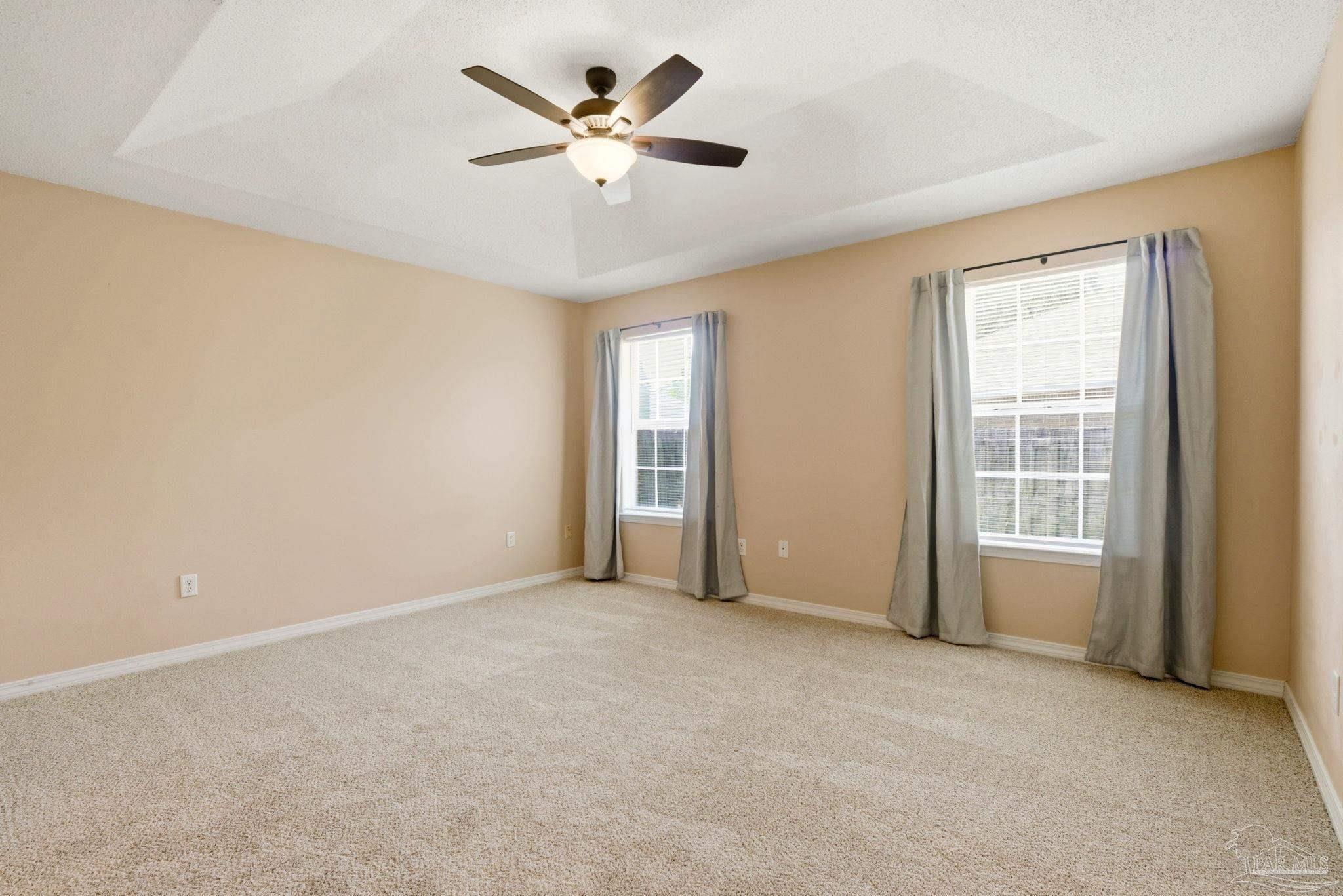 8100 Castle Pointe Way Pensacola, FL 32506 - Photo 23 of 44 an empty room with chandelier fan and windows