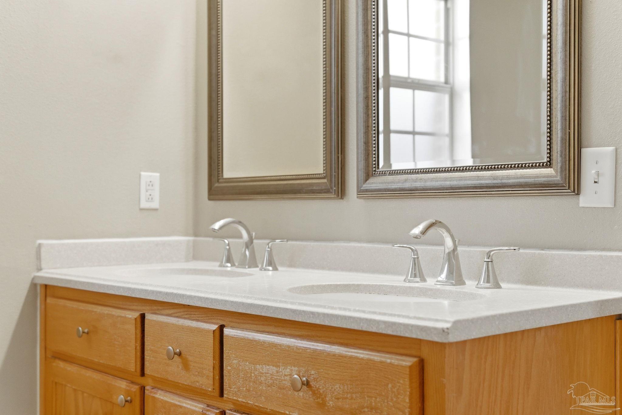 8100 Castle Pointe Way Pensacola, FL 32506 - Photo 30 of 44 a bathroom with a sink and a mirror