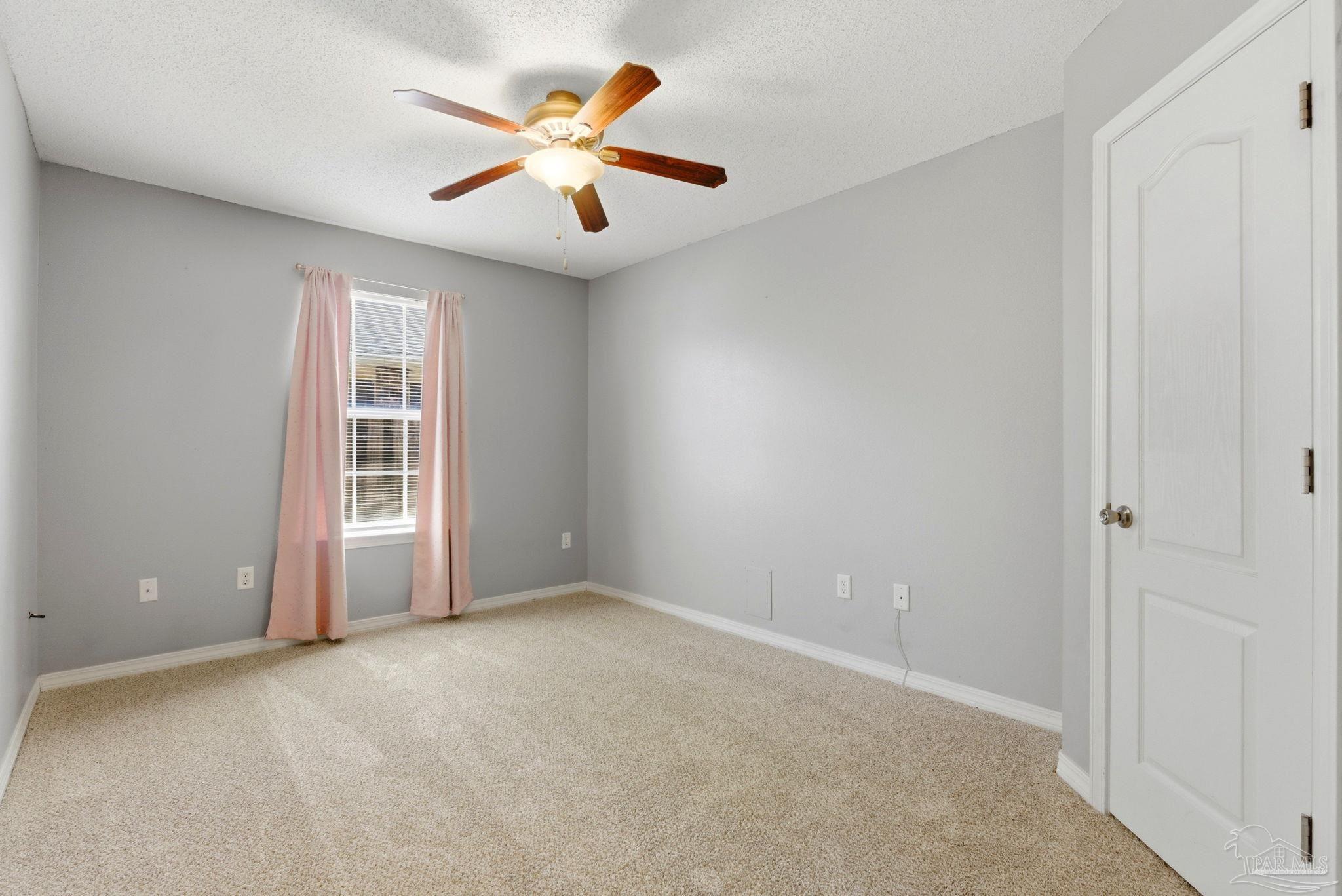 8100 Castle Pointe Way Pensacola, FL 32506 - Photo 37 of 44 an empty room with windows and fan