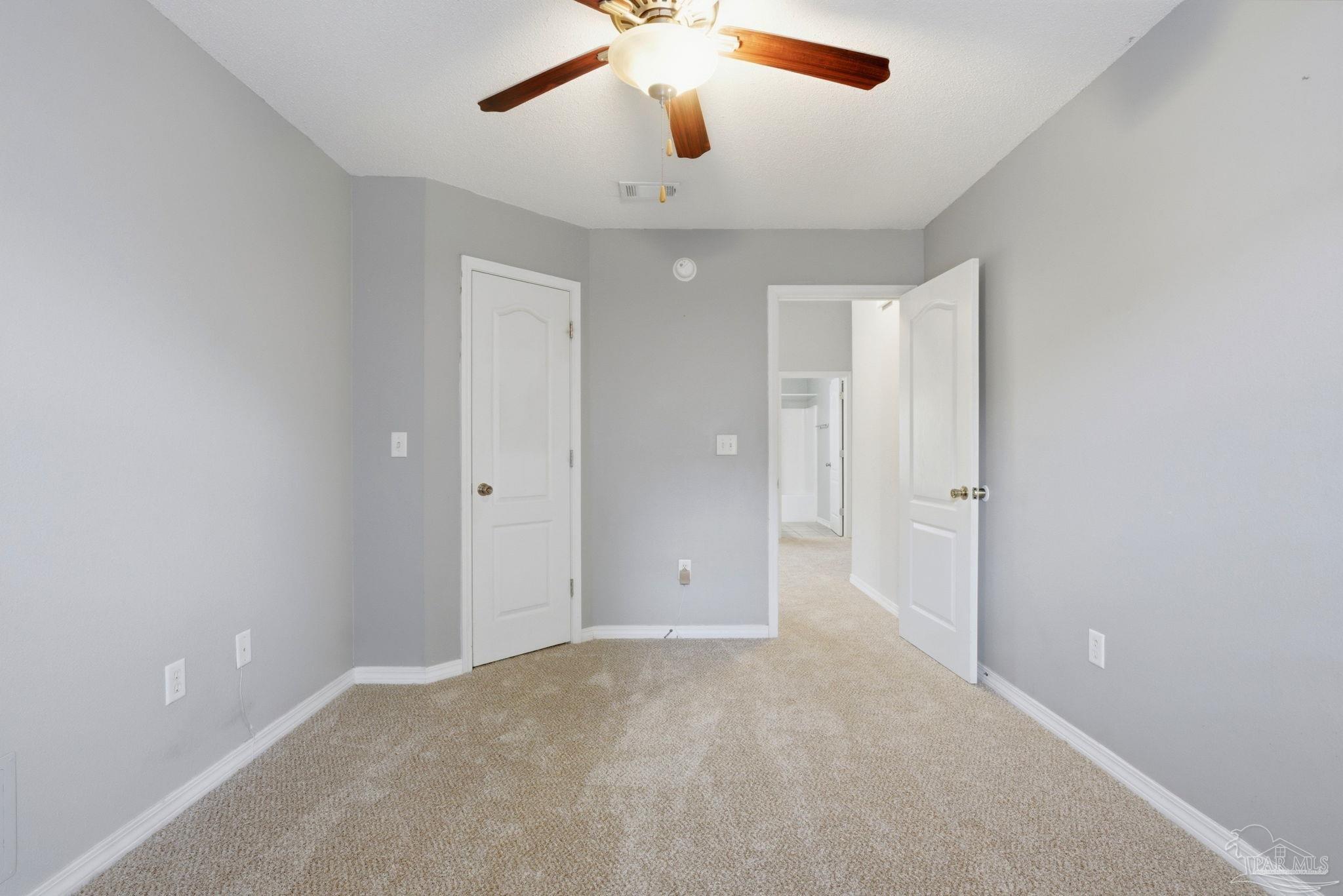 8100 Castle Pointe Way Pensacola, FL 32506 - Photo 38 of 44 an empty room with chandelier fan and windows