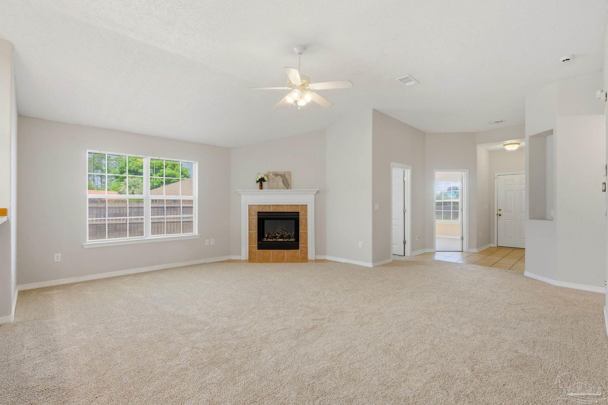 8100 Castle Pointe Way Pensacola, FL 32506 - Photo 8 of 44 an empty room with windows and fireplace
