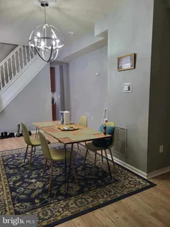 a view of a dining room with furniture and chandelier