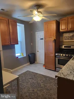 a kitchen with stainless steel appliances granite countertop a refrigerator a stove and a sink with granite countertops