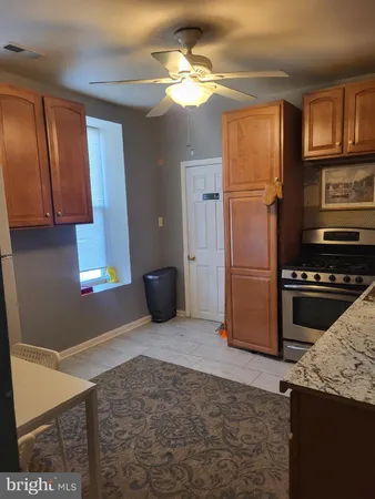 a kitchen with stainless steel appliances granite countertop a refrigerator a stove and a sink with granite countertops