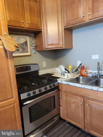 a kitchen with granite countertop stainless steel appliances and cabinets