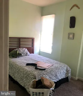 a bedroom with a bed and dresser