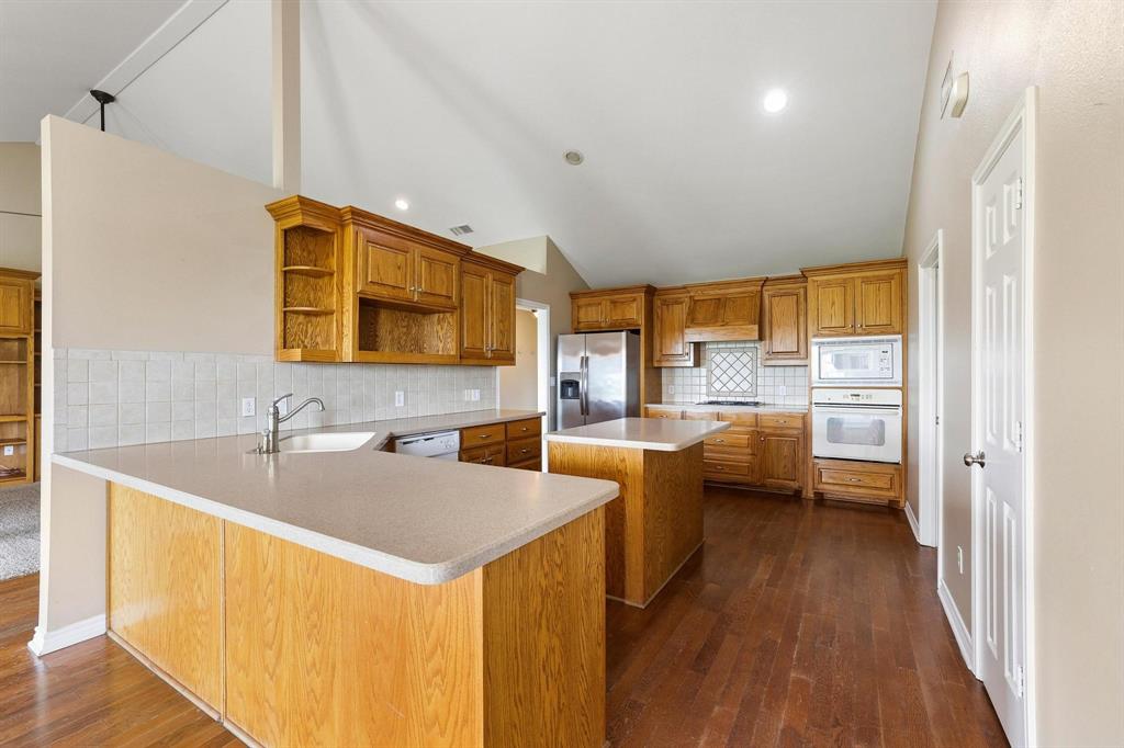 386 Scoggins Road Tioga, TX 76271 - Photo 12 of 30 a kitchen with counter top space and stainless steel appliances