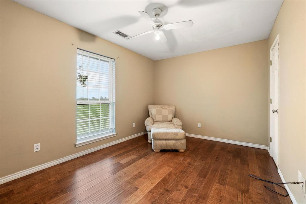 386 Scoggins Road Tioga, TX 76271 - Photo 14 of 30 wooden floor in an empty room with a window