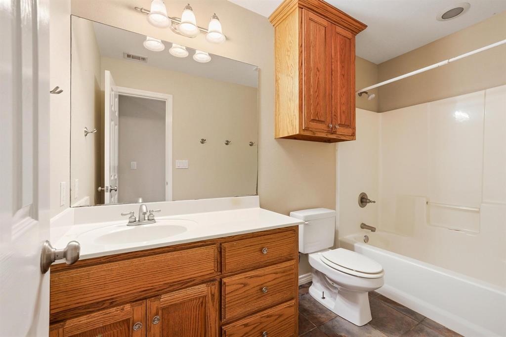 386 Scoggins Road Tioga, TX 76271 - Photo 15 of 30 a bathroom with a sink a toilet and shower