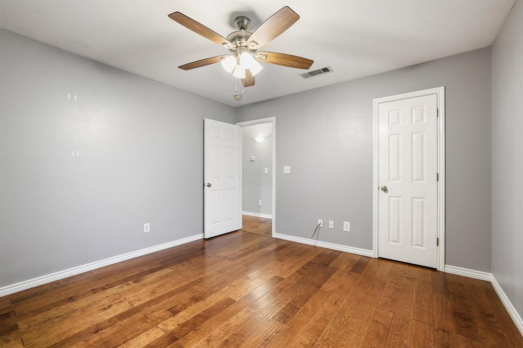 386 Scoggins Road Tioga, TX 76271 - Photo 18 of 30 an empty room with wooden floor and ceiling fan