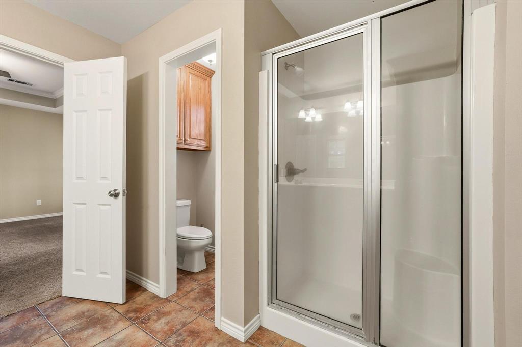 386 Scoggins Road Tioga, TX 76271 - Photo 22 of 30 a bathroom that has a glass shower door