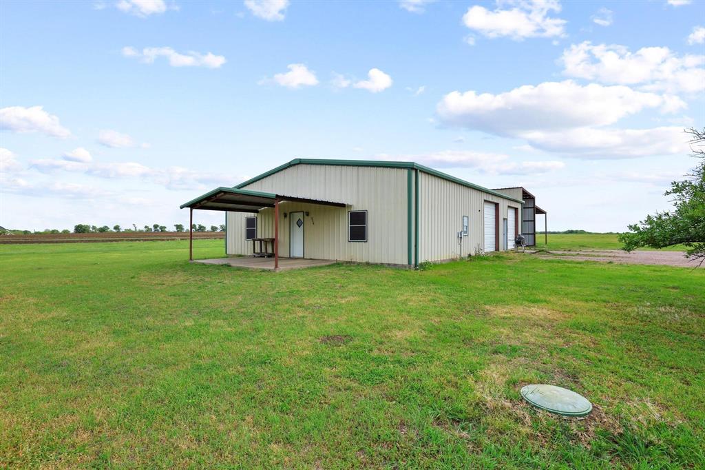 386 Scoggins Road Tioga, TX 76271 - Photo 27 of 30 a backyard of a house with table and chairs