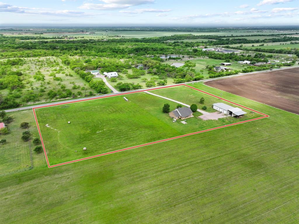 386 Scoggins Road Tioga, TX 76271 - Photo 7 of 30 a view of a field with lawn chairs and a yard