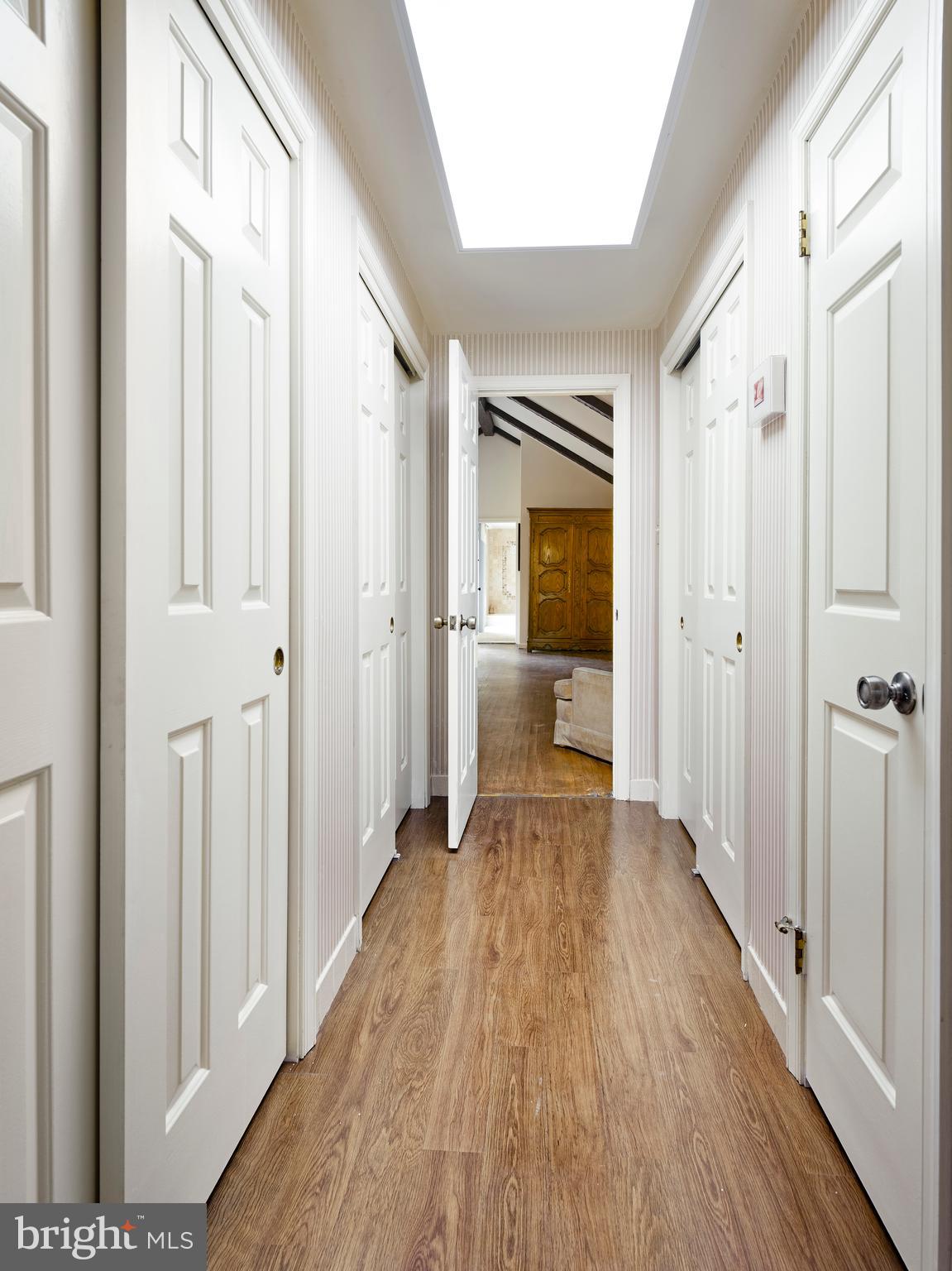 1345 Valley Road Villanova, PA 19085 - Photo 50 of 60 a view of a hallway with wooden floor and a bathroom