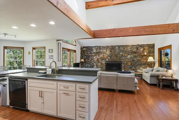 a dining room with furniture and wooden floor