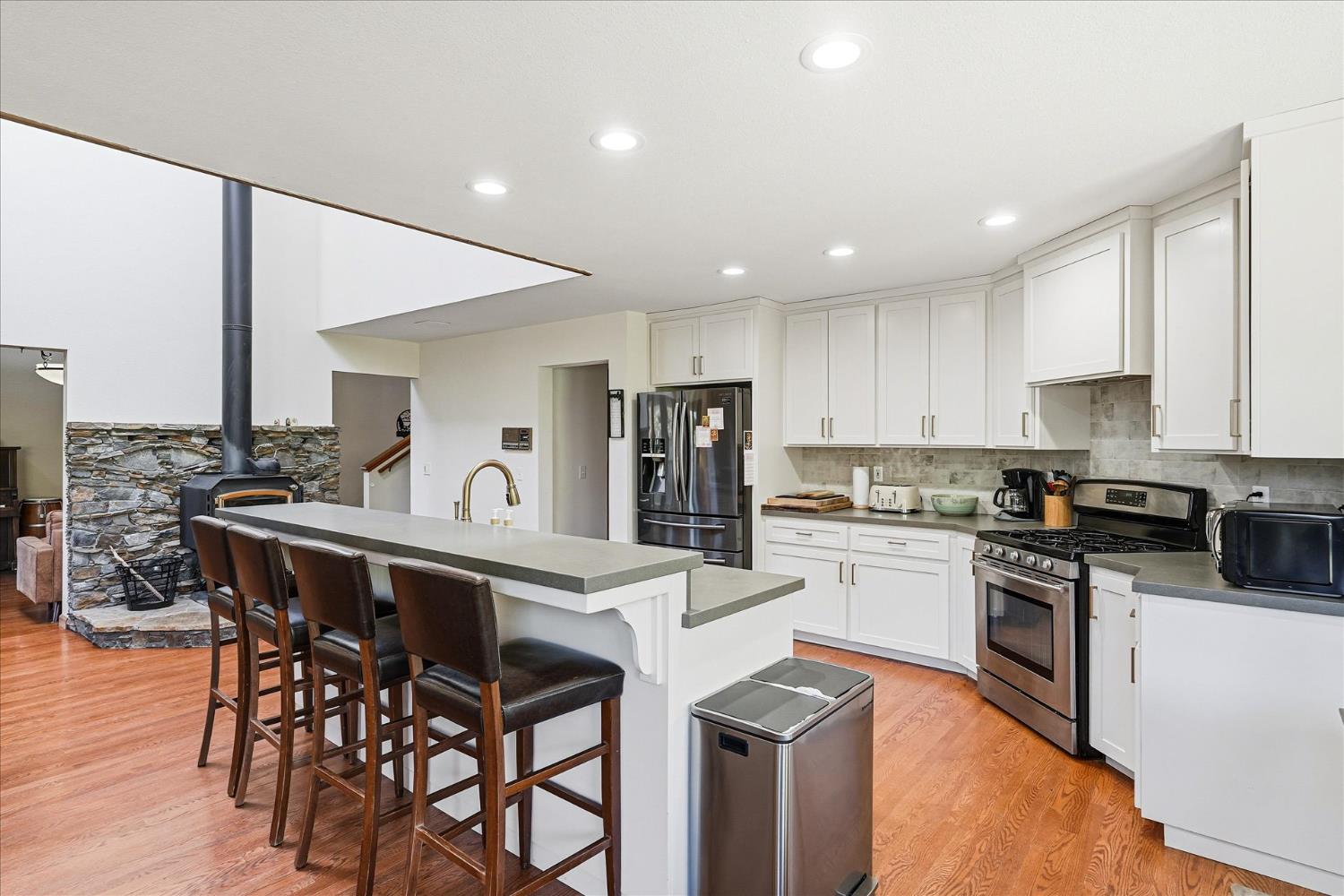 59484 Cascadel Road North Fork, CA 93643 - Photo 17 of 95 a kitchen with stainless steel appliances granite countertop a table chairs sink refrigerator and cabinets