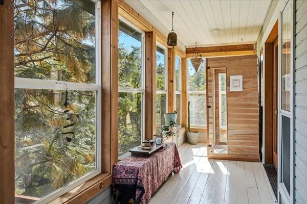 a bathroom with a tub a sink and a large window
