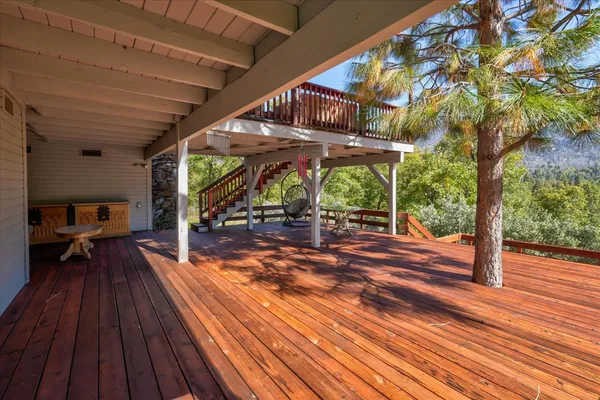 a kitchen with stainless steel appliances granite countertop a stove a refrigerator a dining table and chairs with the ocean view