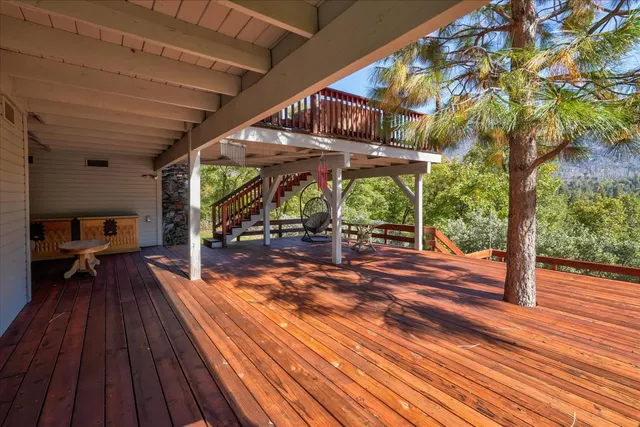 a kitchen with stainless steel appliances granite countertop a stove a refrigerator a dining table and chairs with the ocean view