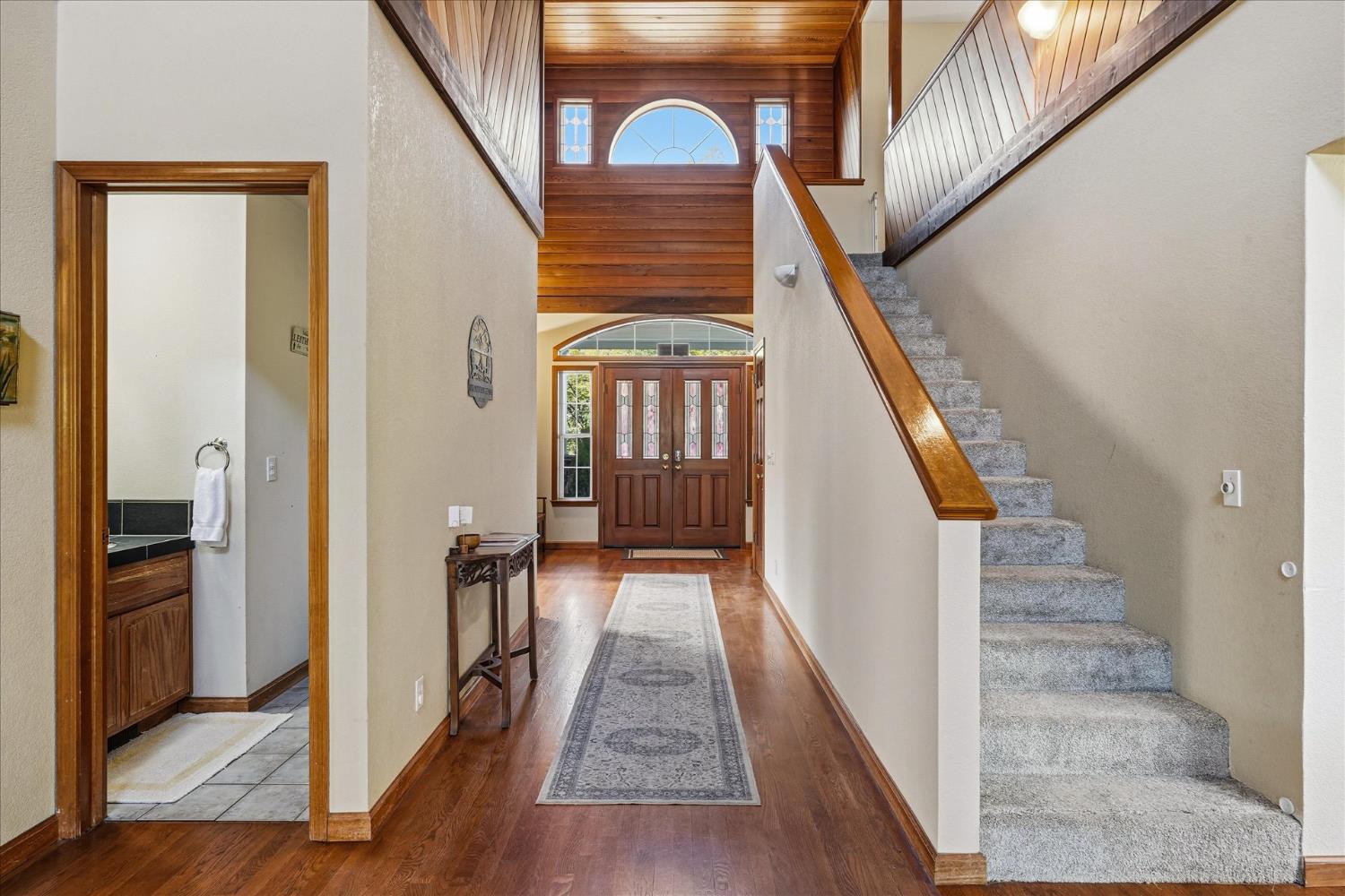 59484 Cascadel Road North Fork, CA 93643 - Photo 7 of 95 a view of a hallway to a livingroom with wooden floor and stairs