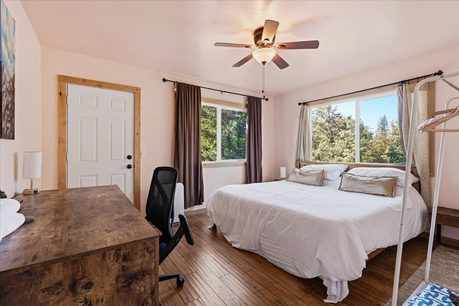 59484 Cascadel Road North Fork, CA 93643 - Photo 76 of 95 a bedroom with a bed a chandelier and a large window
