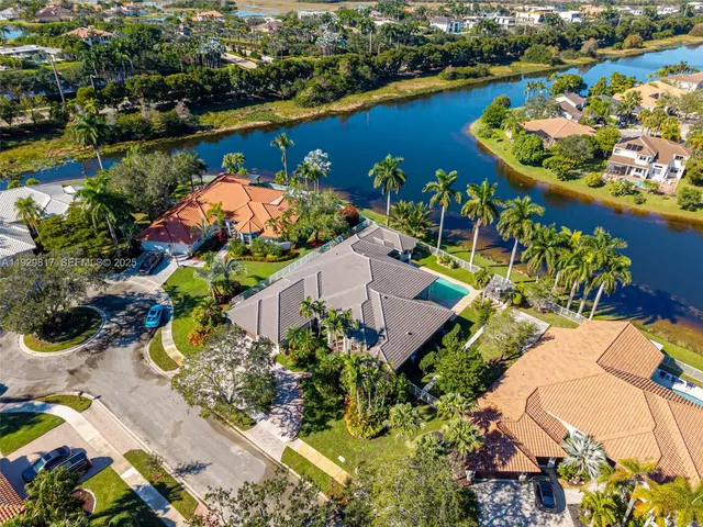 an aerial view of a house with a swimming pool