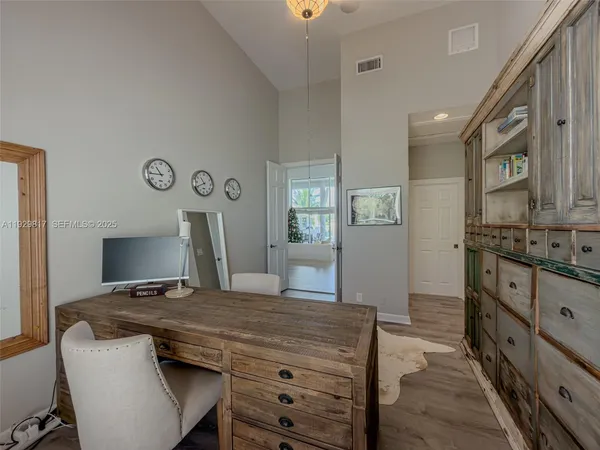 a large white kitchen with a large window
