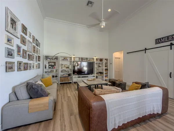 a living room with furniture and a wooden floor