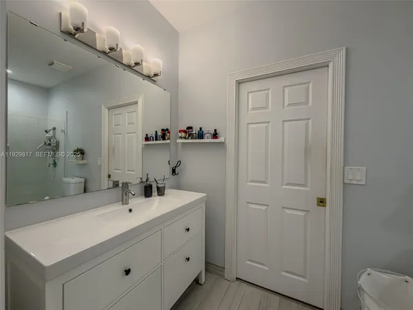 a bathroom with a toilet a sink and mirror