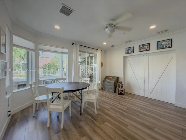 a building outdoor space with patio furniture and potted plants