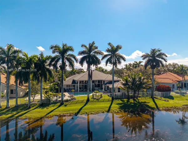 an aerial view of a house with a yard and swimming pool