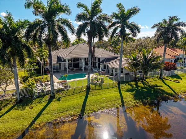an aerial view of a house with a yard and garden