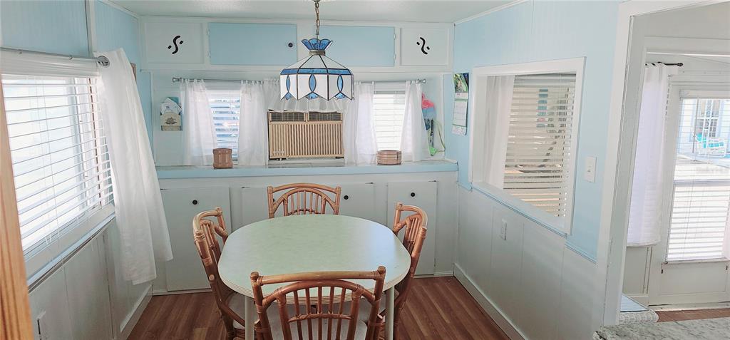 10315 Cortez Road West, Unit 714 Bradenton, FL 34210 - Photo 12 of 26 a view of a dining room with furniture window and wooden floor