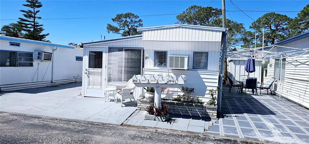 10315 Cortez Road West, Unit 714 Bradenton, FL 34210 - Photo 3 of 26 a front view of a house with table and chairs