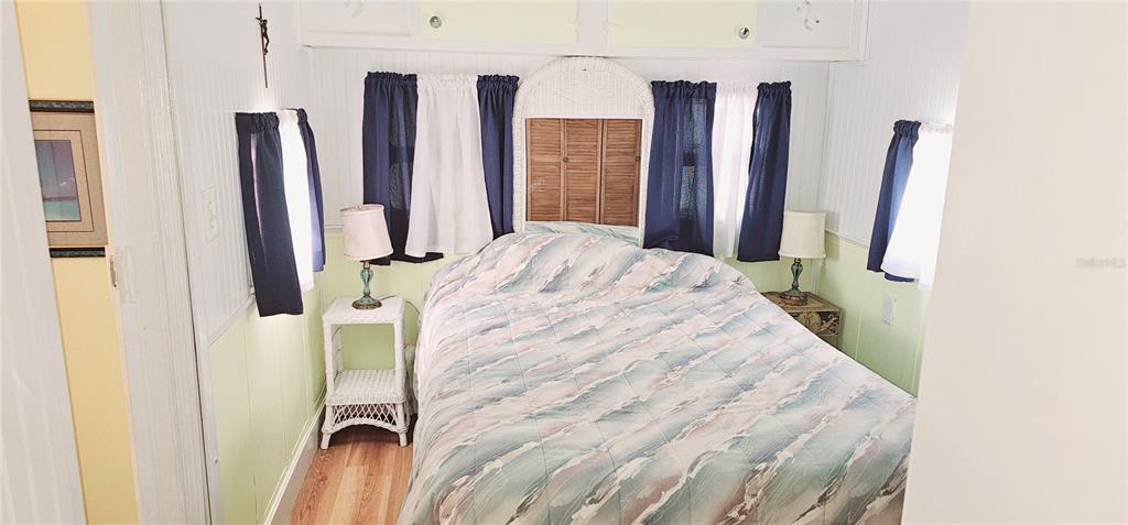 10315 Cortez Road West, Unit 714 Bradenton, FL 34210 - Photo 7 of 26 a bedroom with a bed and a large mirror