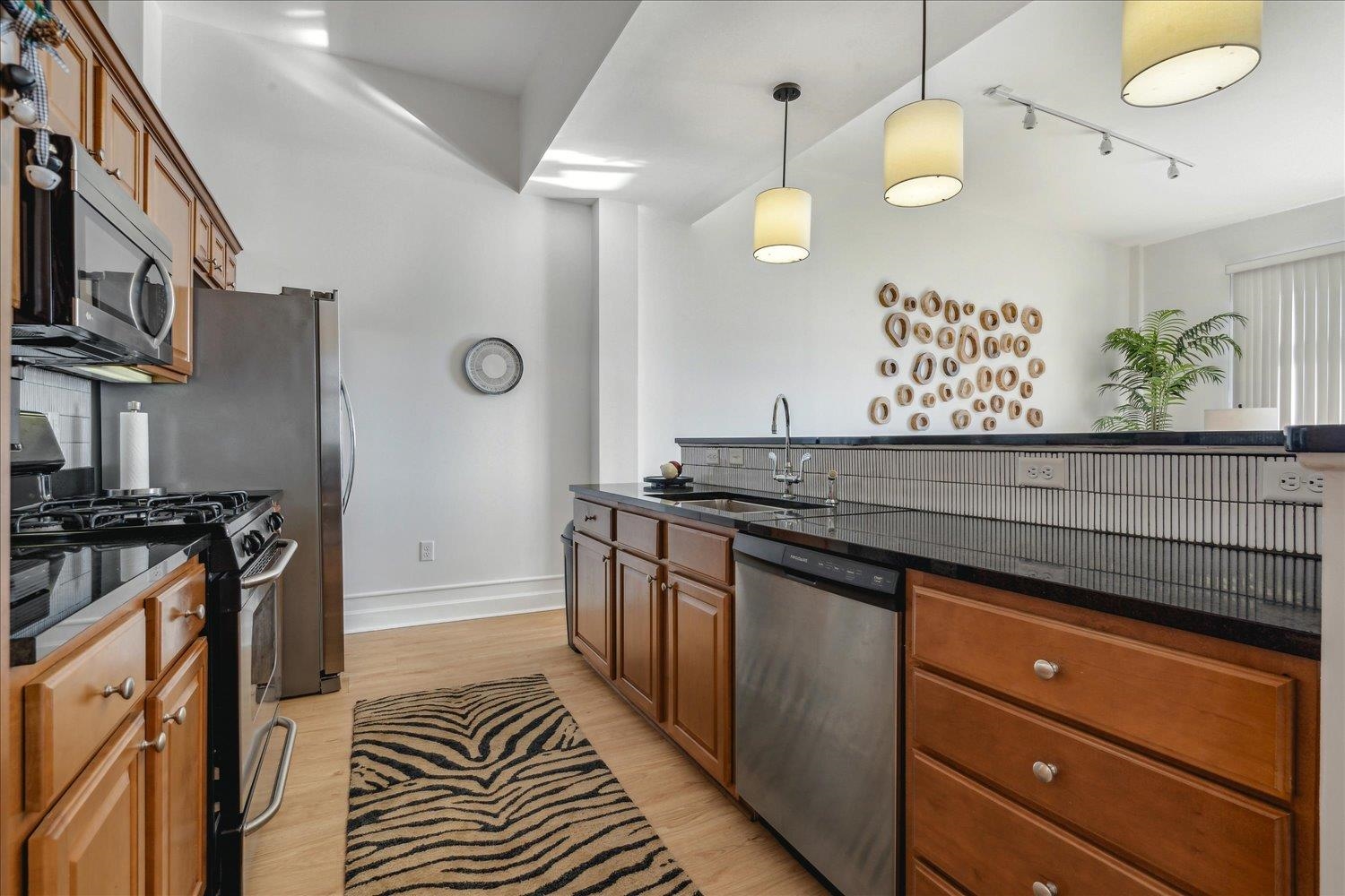 648 Riverside Drive, Unit 411 Memphis, TN 38103 - Photo 9 of 32 a kitchen with stainless steel appliances granite countertop a stove and a sink