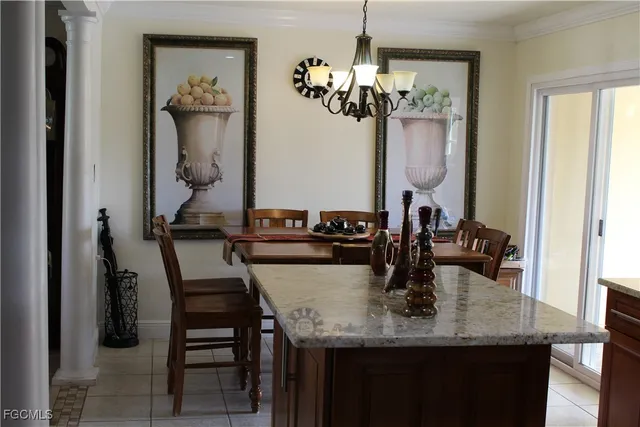 a kitchen with granite countertop a refrigerator and a sink