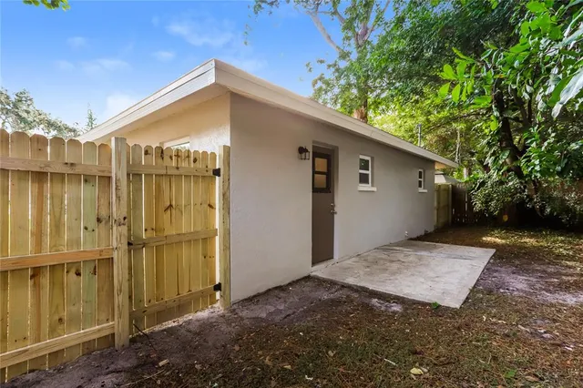 a backyard of a house with a tree