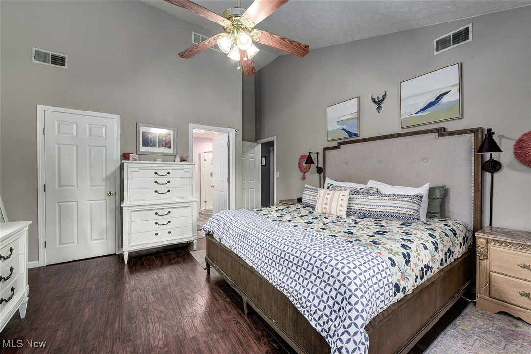 5927 Highland Road Highland Heights, OH 44143 - Photo 16 of 22 Bedroom featuring ensuite bath, ceiling fan, dark hardwood / wood-style flooring, high vaulted ceiling, and a textured ceiling