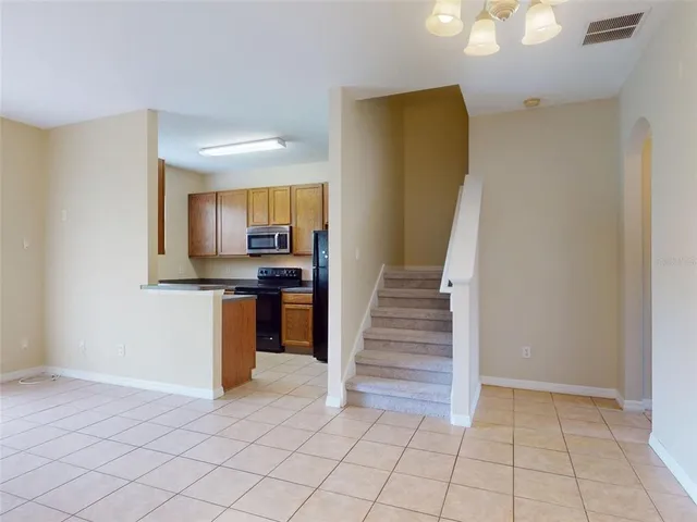 a view of kitchen with cabinets and window