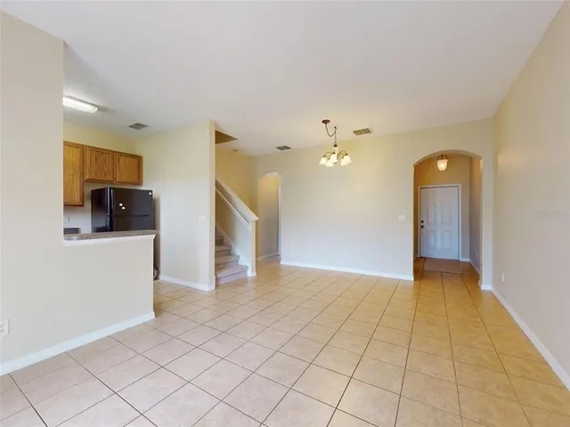 a view of a hallway with wooden floor and a living room