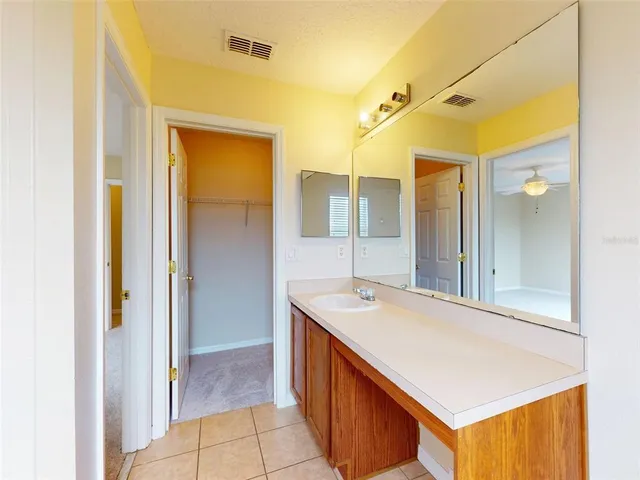 a bathroom with a tub sink and mirror