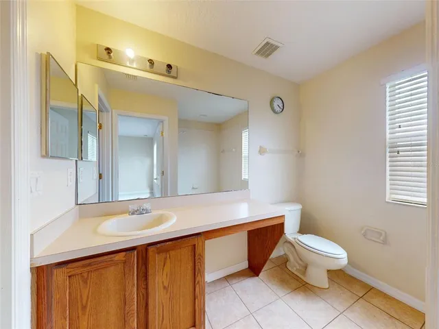 a bathroom with a sink a toilet a mirror and shower