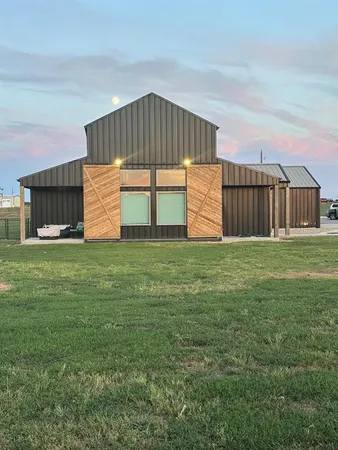 a front view of house with yard and garage